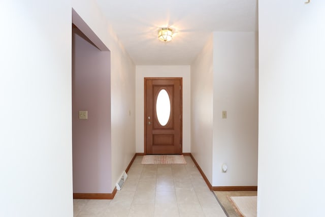 entryway with light tile patterned floors, visible vents, and baseboards