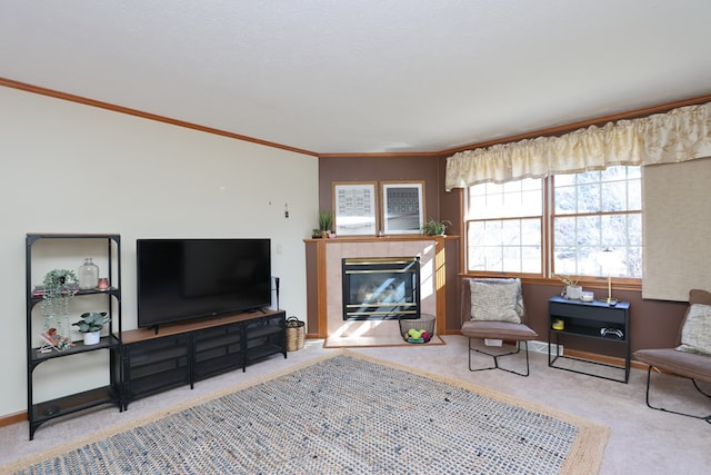 living room with baseboards, carpet floors, crown molding, and a tile fireplace