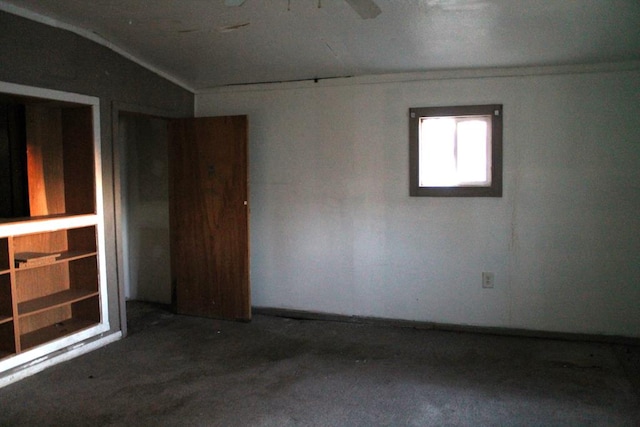 unfurnished room with lofted ceiling