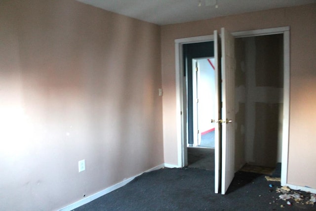 unfurnished bedroom featuring dark colored carpet