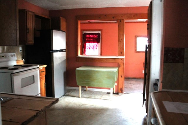 kitchen featuring refrigerator and white electric range