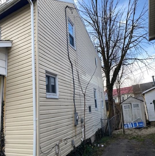 view of property exterior featuring a shed