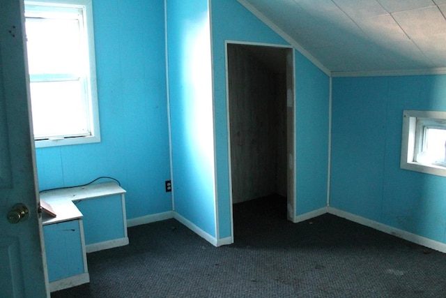 bonus room featuring dark colored carpet and vaulted ceiling