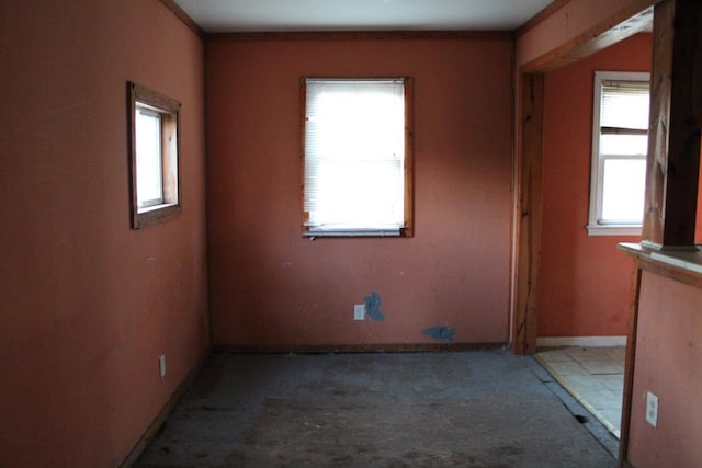 unfurnished room with crown molding