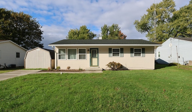 ranch-style home with central AC unit, a storage shed, and a front lawn