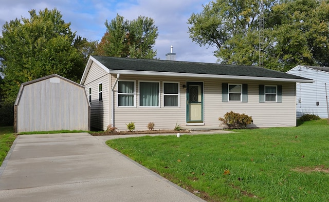 ranch-style home with a shed and a front lawn