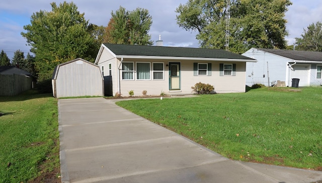 single story home featuring a front lawn and a storage shed