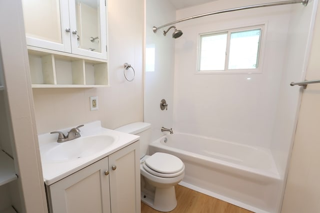 full bathroom featuring shower / bathing tub combination, wood-type flooring, vanity, and toilet