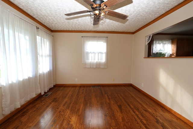 spare room with a textured ceiling, ceiling fan, crown molding, and dark hardwood / wood-style floors