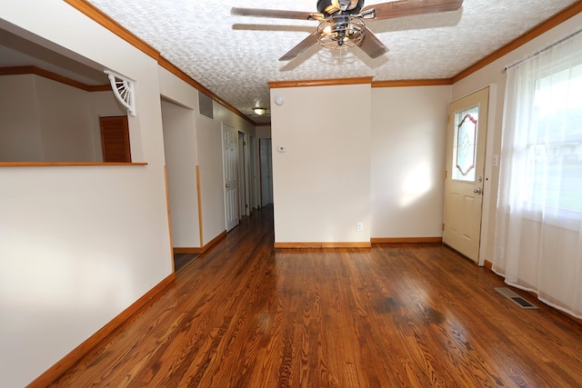 entrance foyer featuring a textured ceiling, ceiling fan, ornamental molding, and dark wood-type flooring