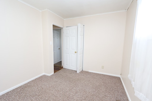 carpeted empty room featuring ornamental molding