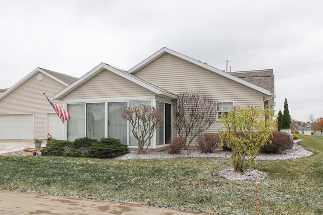 ranch-style home featuring a front yard and a garage