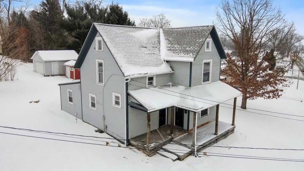 view of front of property with a storage shed