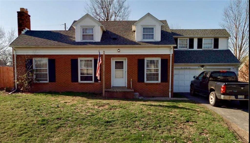 679 Coleman Rd, Mansfield, OH 44903 - view of front of house with brick siding, driveway, a chimney, and a garage