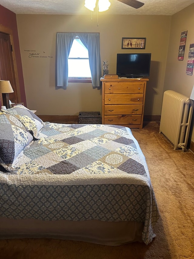 carpeted bedroom featuring radiator heating unit, a textured ceiling, and ceiling fan