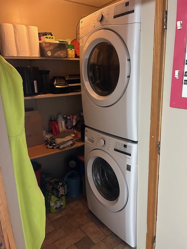 laundry area with stacked washer and clothes dryer