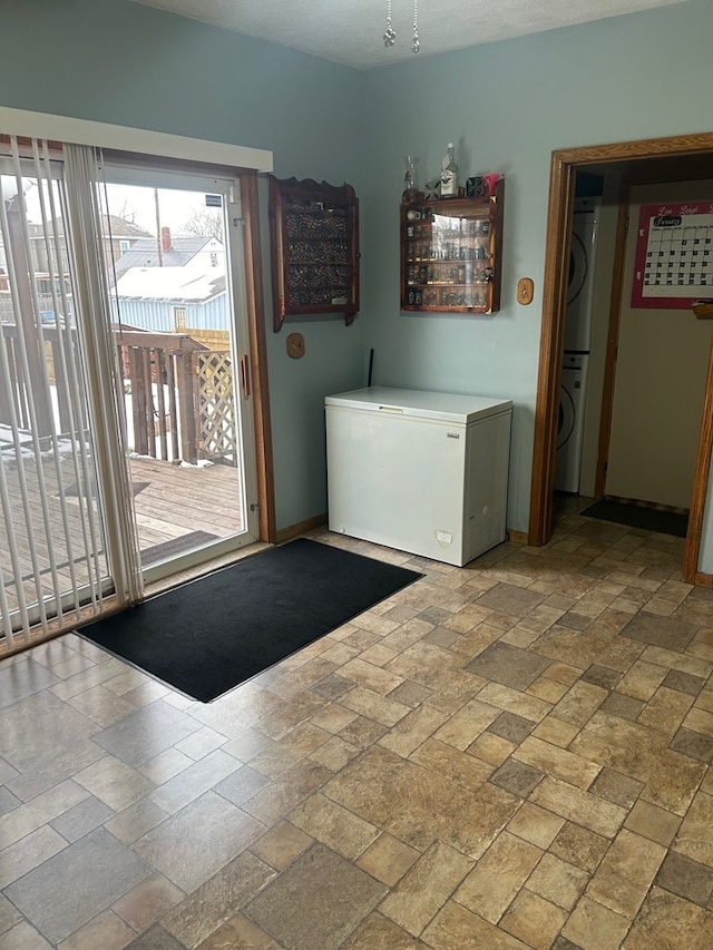 laundry area with stacked washer / dryer