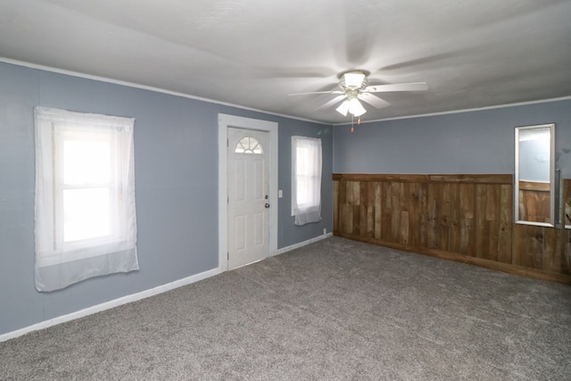 entrance foyer featuring carpet flooring, ceiling fan, and a healthy amount of sunlight