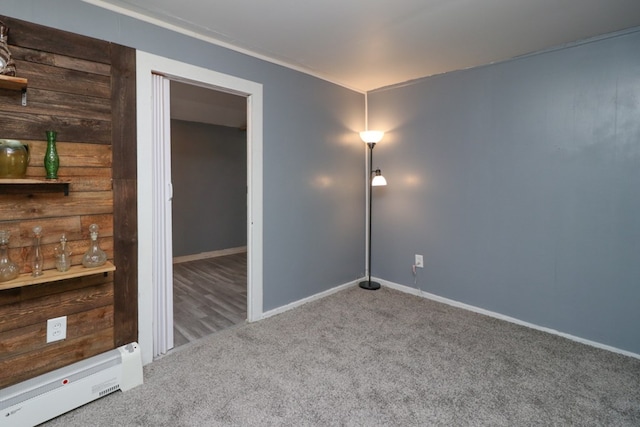 carpeted empty room with a baseboard radiator