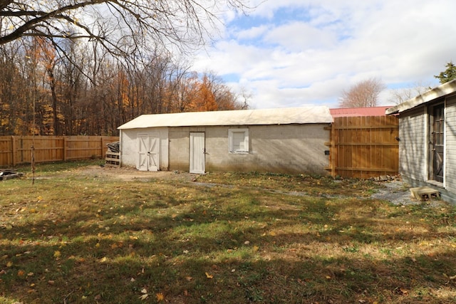 view of outbuilding featuring a lawn