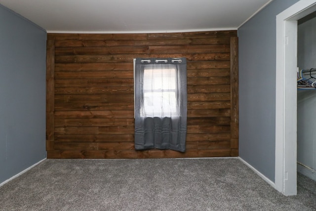 unfurnished room with dark carpet