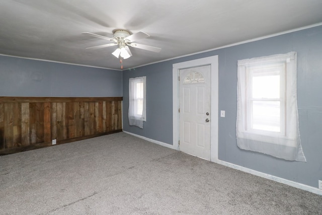 interior space featuring ceiling fan and crown molding