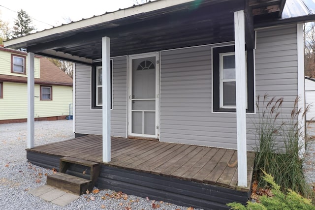 wooden terrace featuring covered porch