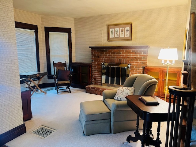 living room with carpet flooring and a brick fireplace