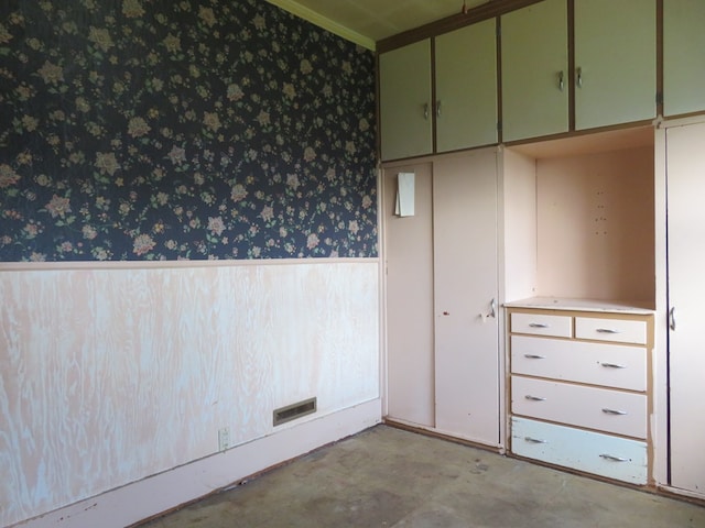 875 E Walnut St, Galion, OH 44833 - unfurnished room featuring wallpapered walls, a wainscoted wall, concrete floors, and ornamental molding
