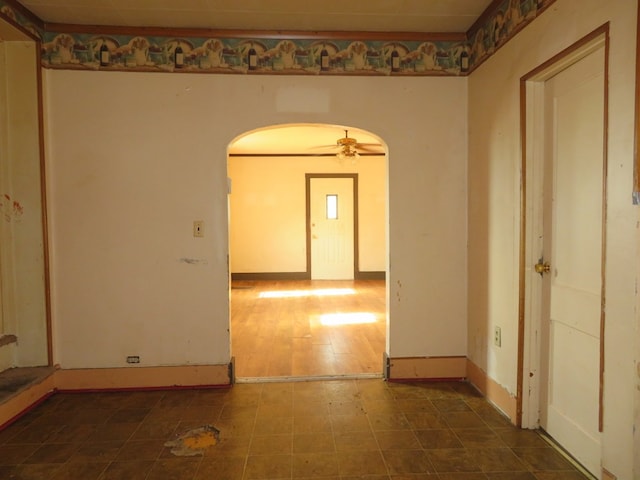 875 E Walnut St, Galion, OH 44833 - unfurnished room featuring arched walkways, ceiling fan, and baseboards