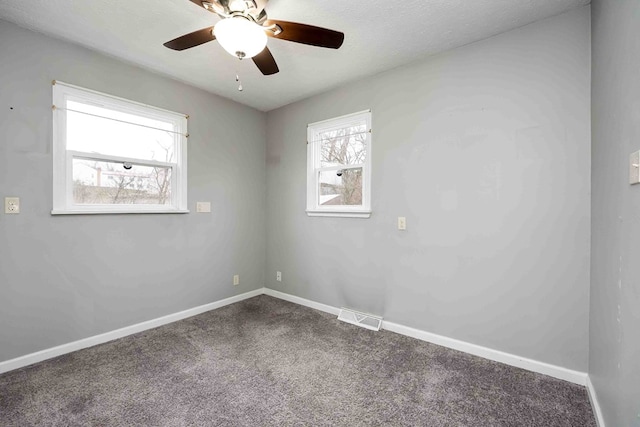 carpeted spare room with ceiling fan