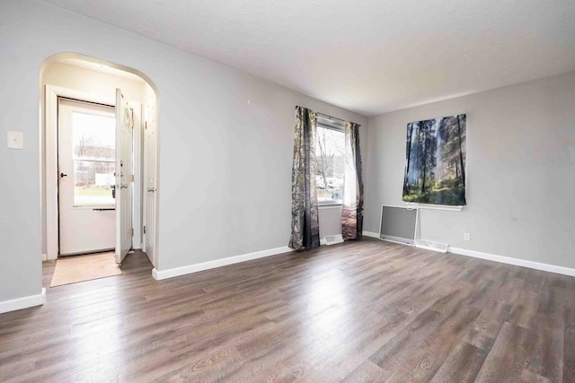 spare room with dark hardwood / wood-style flooring and a textured ceiling