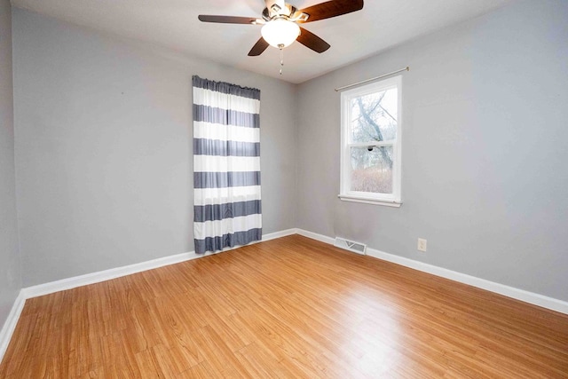 empty room featuring ceiling fan and hardwood / wood-style flooring