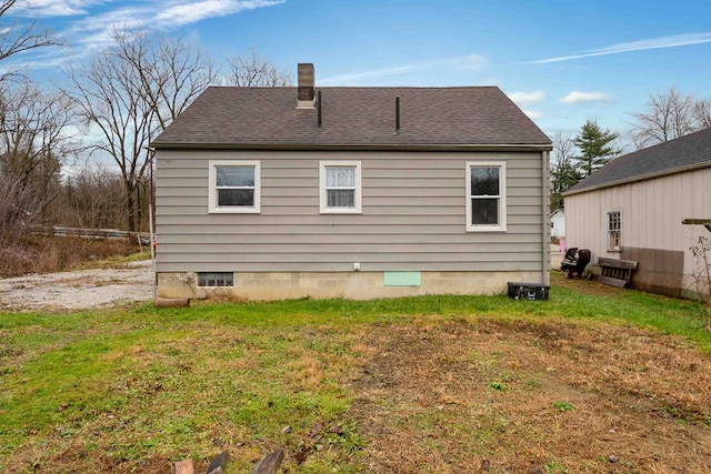 rear view of house with a yard