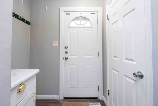 foyer entrance featuring dark wood-type flooring