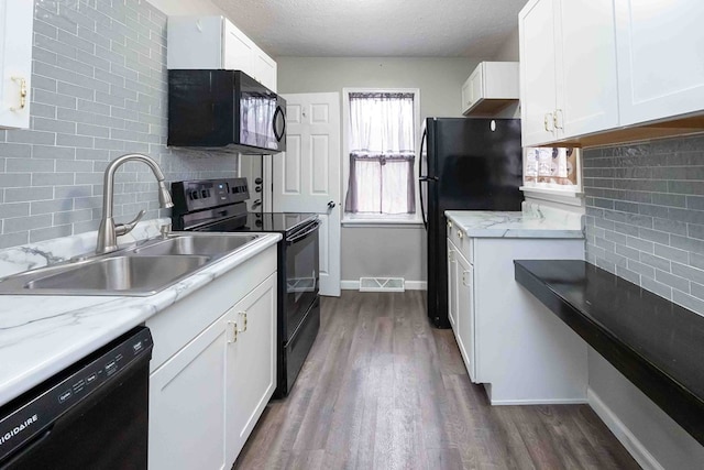 kitchen featuring backsplash, black appliances, white cabinets, sink, and a textured ceiling