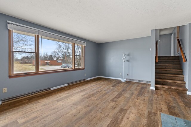 snowy yard with central AC unit and a sunroom