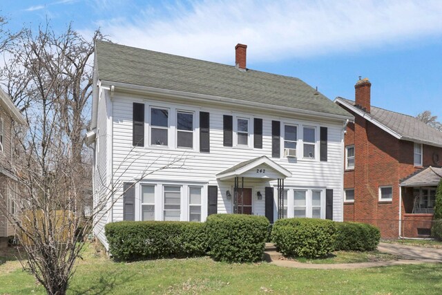 242 Davis Rd, Mansfield, OH 44907 - colonial-style house featuring a chimney and a front yard