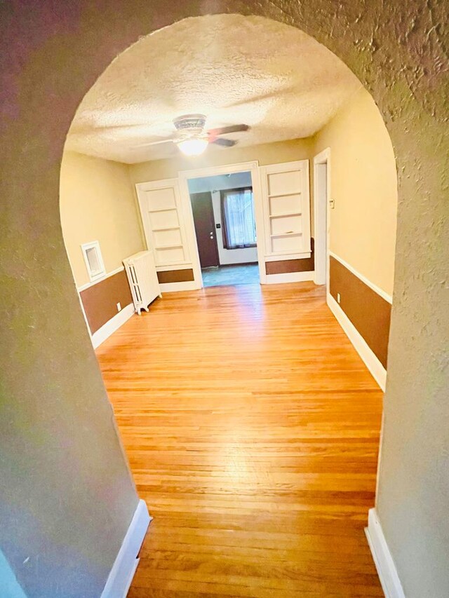 242 Davis Rd, Mansfield, OH 44907 - corridor with arched walkways, light wood-style floors, and baseboards
