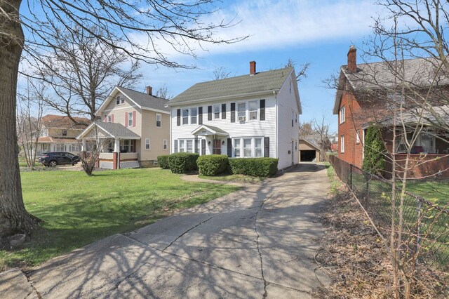 242 Davis Rd, Mansfield, OH 44907 - view of front of home featuring a chimney, a front lawn, concrete driveway, and fence