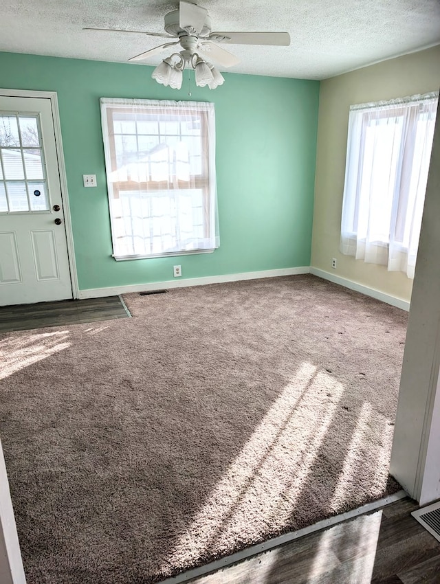 spare room featuring ceiling fan and a textured ceiling