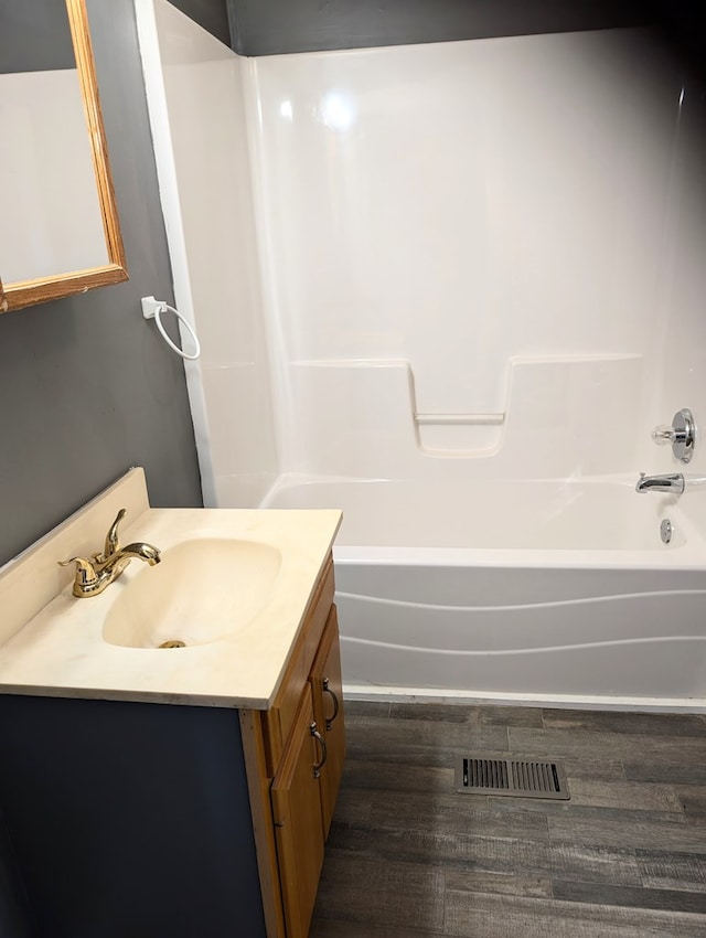 bathroom featuring vanity, hardwood / wood-style flooring, and shower / bath combination