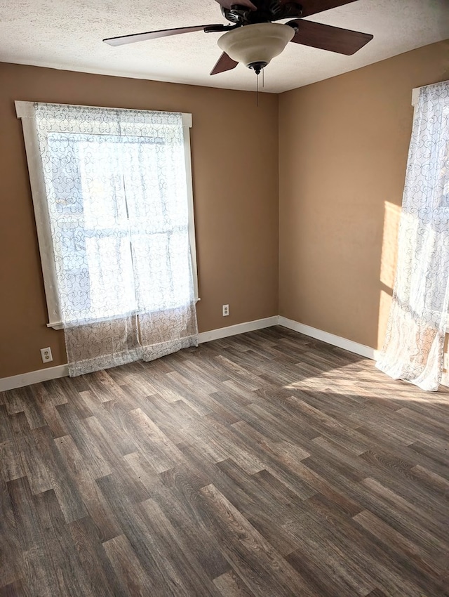 unfurnished room with dark hardwood / wood-style floors, a textured ceiling, and ceiling fan