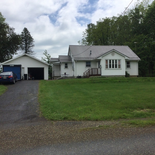 1009 Twp Rd Unit 2156, Ashland, OH 44805 - single story home featuring a garage, a front lawn, metal roof, and an outbuilding