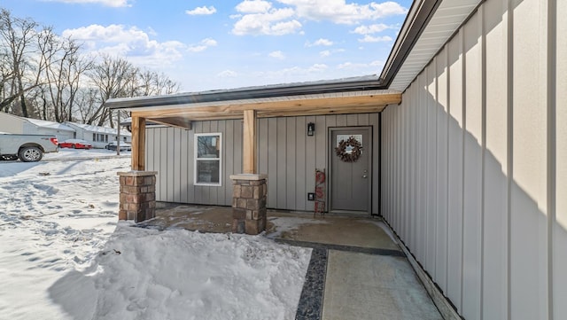 view of snow covered property entrance