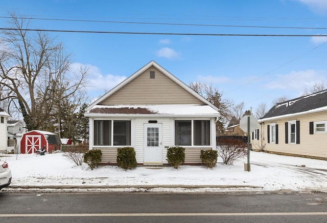 bungalow-style house featuring a storage shed