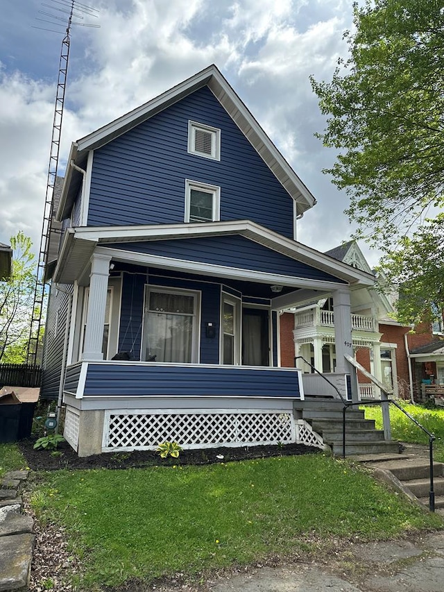 view of front facade featuring covered porch and a front yard