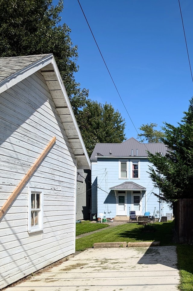 rear view of property featuring a yard