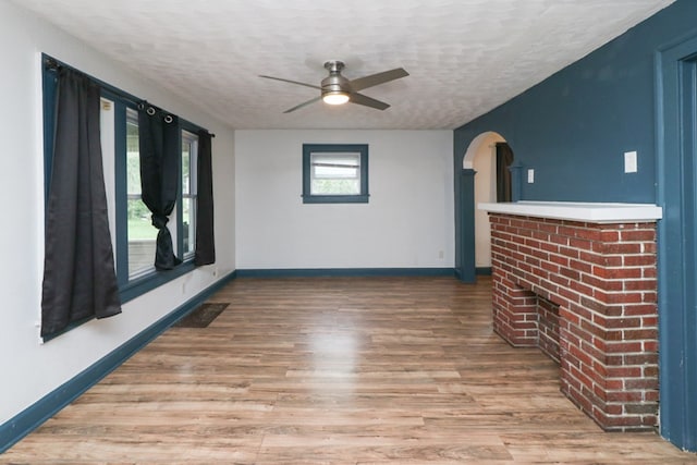 460 W Dickson, Mansfield, OH 44903 - unfurnished living room with ceiling fan, a textured ceiling, wood finished floors, and arched walkways