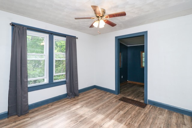 460 W Dickson, Mansfield, OH 44903 - empty room with light wood finished floors and ceiling fan